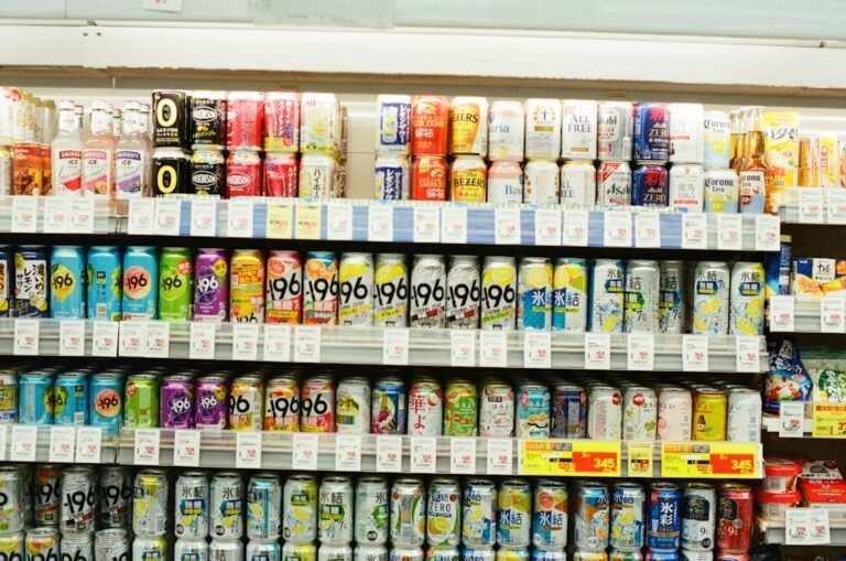 Beverage cans on a grocery store shelf representing Dr Pepper's wide retail availability