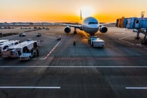 Airplane at an airport terminal during sunrise