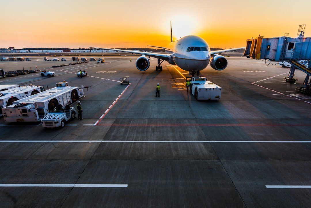 Airplane at an airport terminal during sunrise