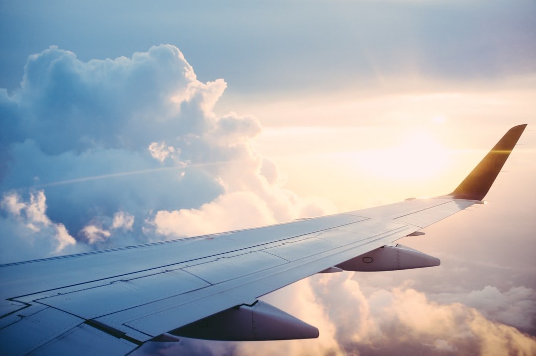 Airplane wing above clouds during flight
