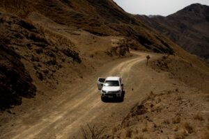 Pickup truck driving through mountain terrain