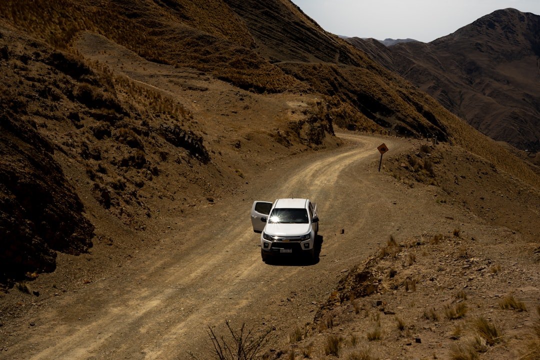Pickup truck driving through mountain terrain