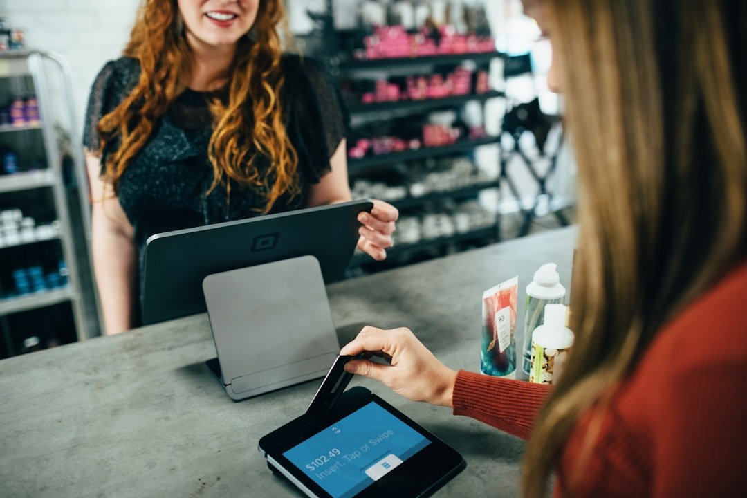 Person paying at a store checkout counter